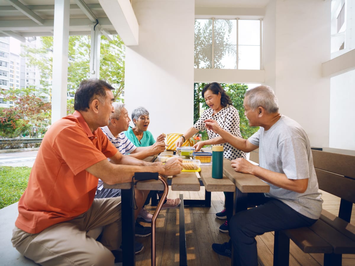 Seniors at a void deck table